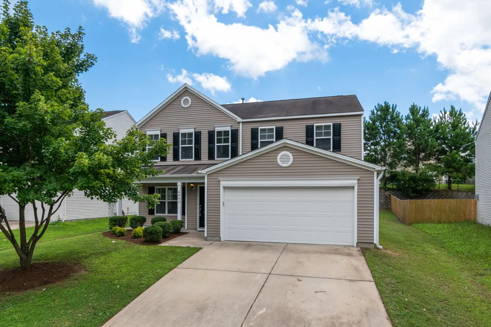 Two story home with fresh siding and a two car garage